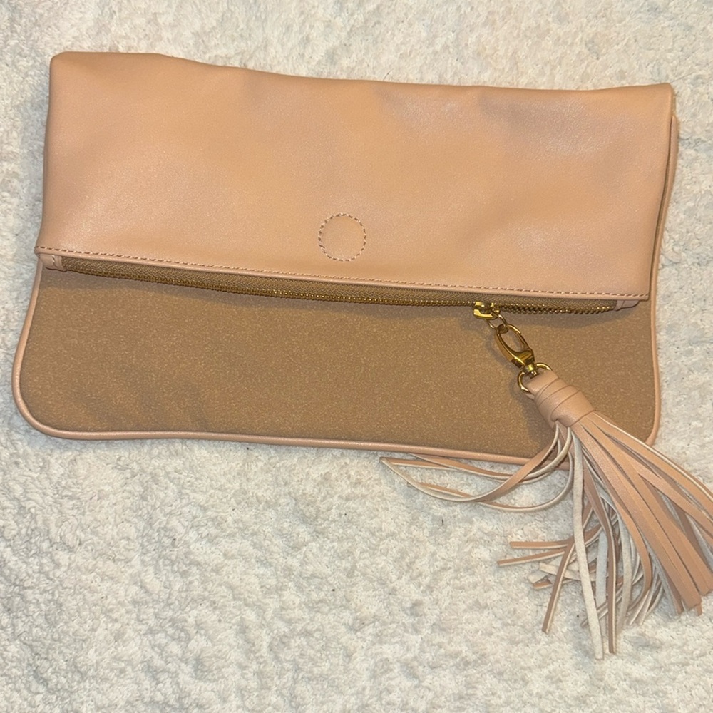 Zipper foldover clutch with tassel.